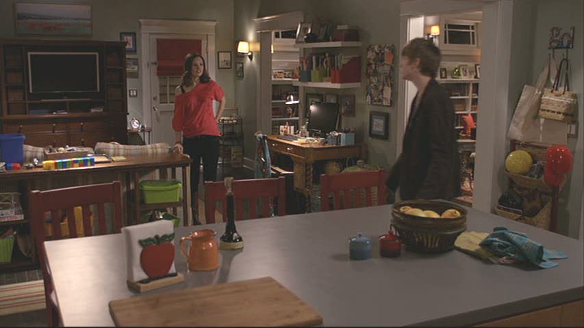 A group of people standing in a kitchen