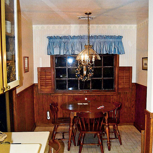 A kitchen with a dining room table before remodel