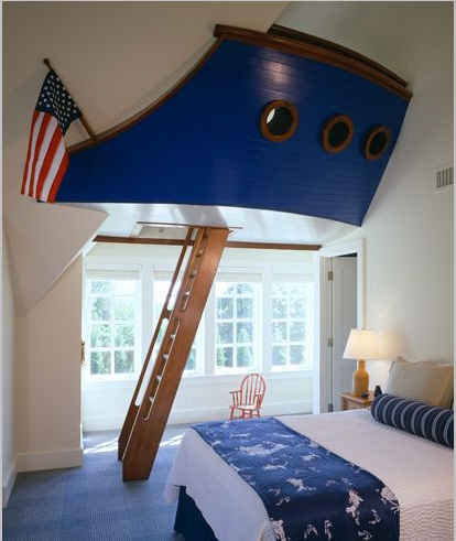 boy\'s bedroom with nautical theme and ship hall hanging on wall with ladder