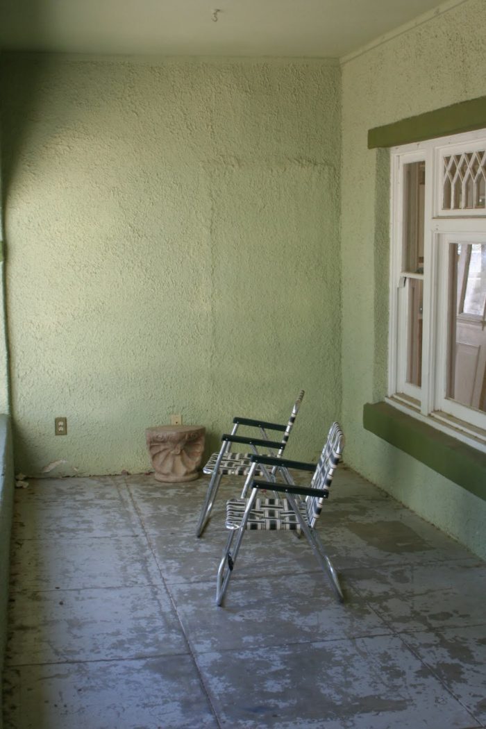 front porch with lawn chairs before remodel