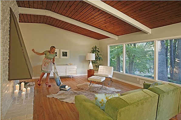 woman sweeping living room