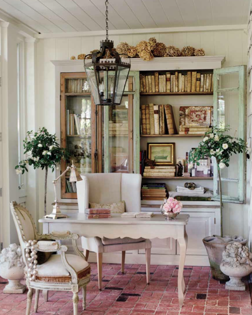 desk and hutch in sunroom with brick floor