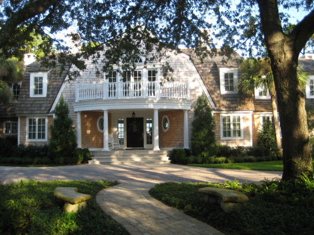 front exterior of shingle style house with black door