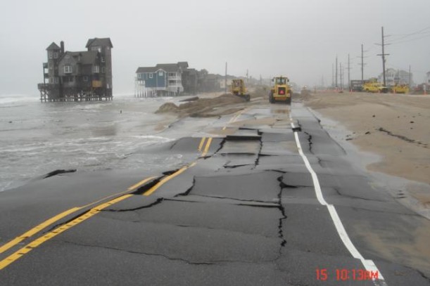 buckling road along the beach after storm