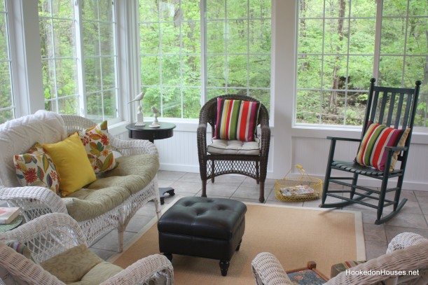 wicker chair and sofa in sunroom before it was decorated