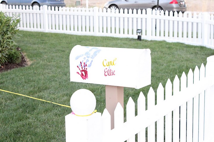 A close up of a mailbox and picket fence