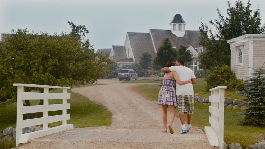 couple walking arm in arm toward the house in Jumping the Broom