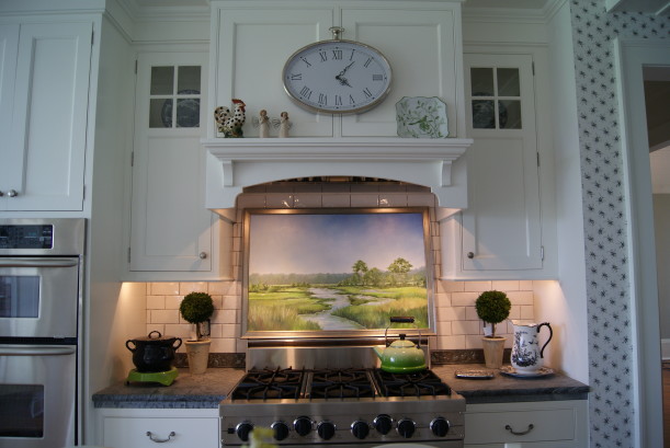 A kitchen with a clock over range