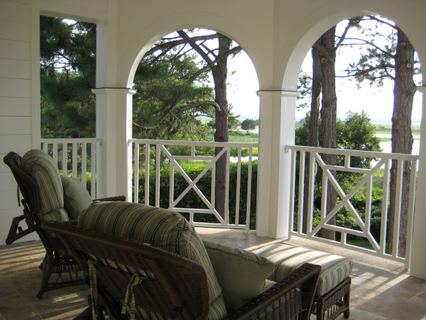 chair on covered balcony with view of the marsh