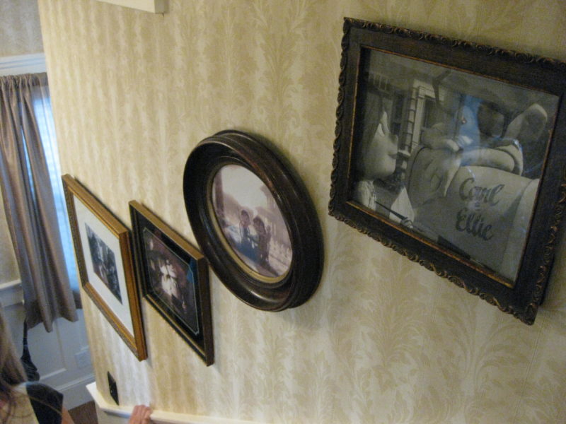 looking down staircase at framed photos