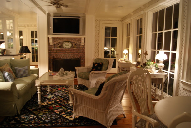 sunroom with wicker furniture and brick fireplace