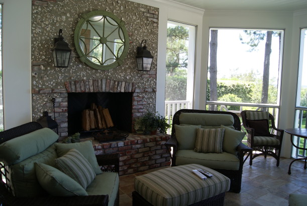 screened porch with brick fireplace