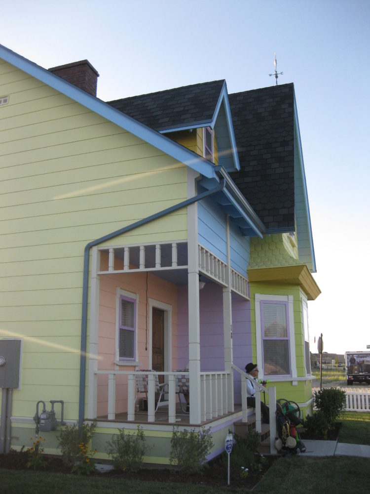 front porch of Up house with yellow, pink, blue, and purple siding