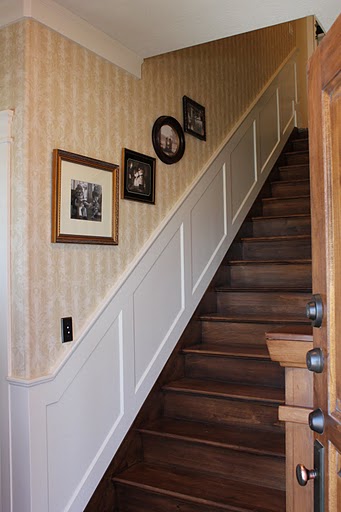 staircase with framed family photos