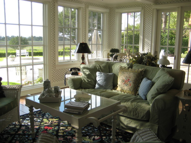 sunroom with green sofa