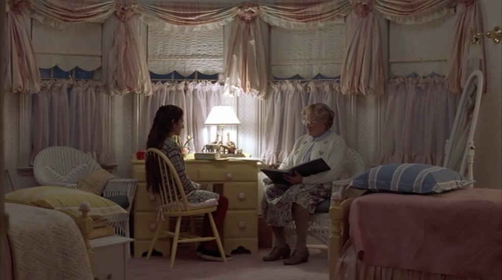 A bedroom with a bed and a chair in a room