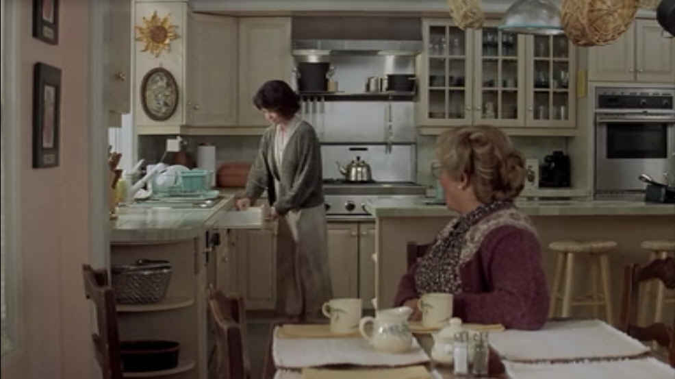 A person standing in a kitchen, with Mrs. Doubtfire