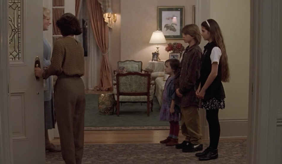 children standing in front entry of house as Mrs. Doubtfire enters