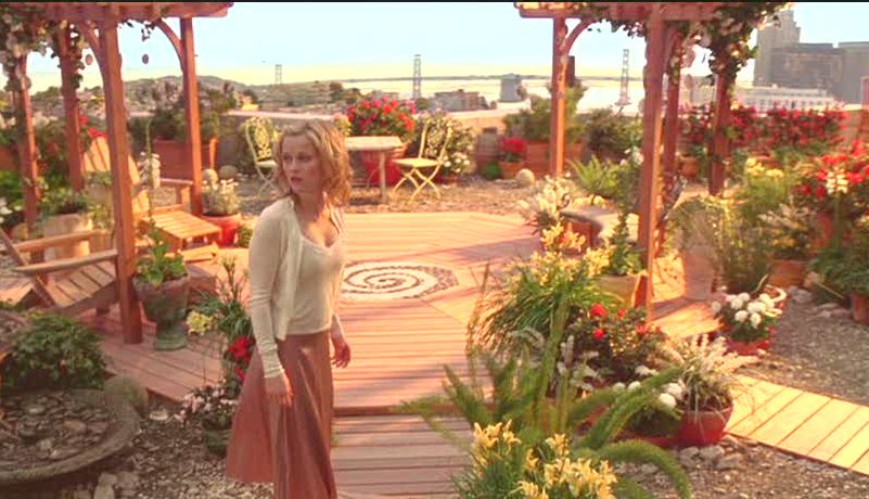 Reese Witherspoon standing on rooftop garden