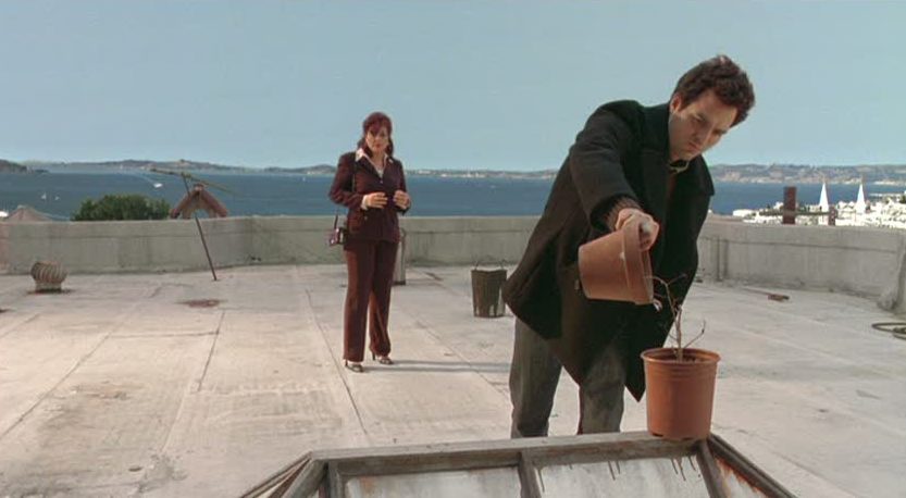 characters standing on roof of apartment building