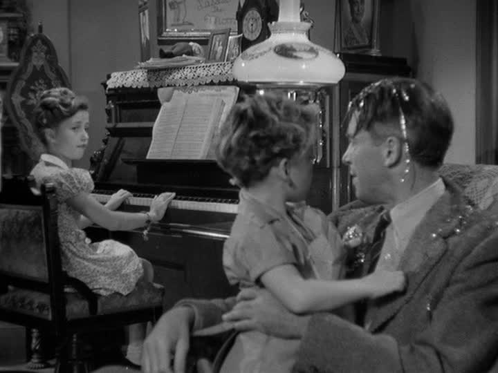 George Bailey and two kids sit at piano