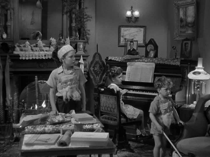 children in the living room in front of piano