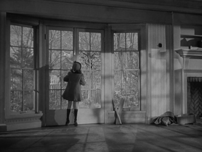 Susan looking out the bay window of her new house