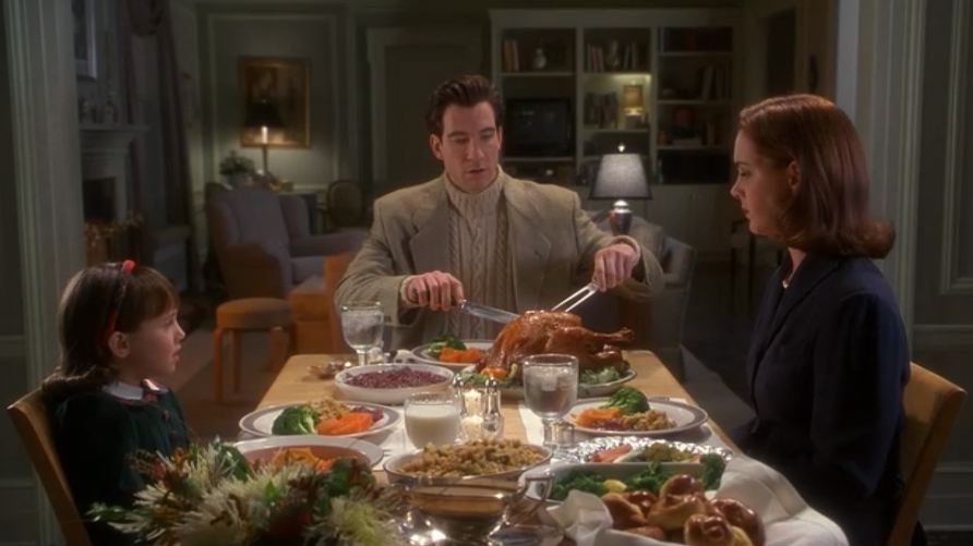 A group of people sitting at a table eating food