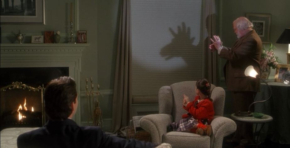 making shadow puppets on the wall of the apartment