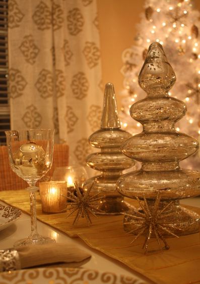 A table with mercury glass trees and candlelight