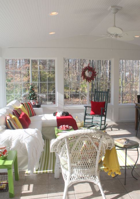 sunroom decorated for Christmas in red and green