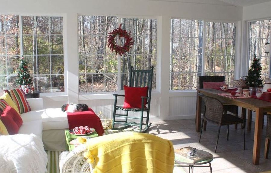 sunroom decorated for Christmas in red and green