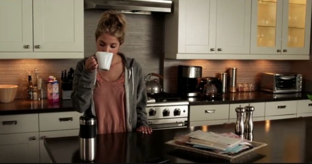 Hanna drinking coffee in her kitchen