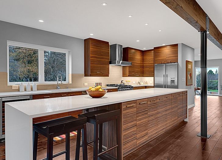 A kitchen with an island in the middle of a room