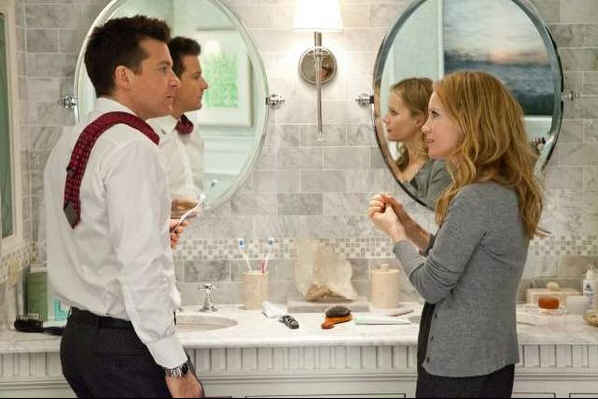 couple standing at dual sinks in bathroom