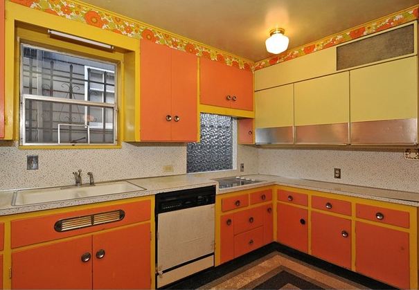 kitchen with orange flowered wallpaper before remodel