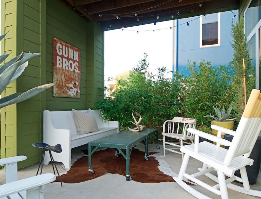 back patio with church pew painted white and rocking chairs