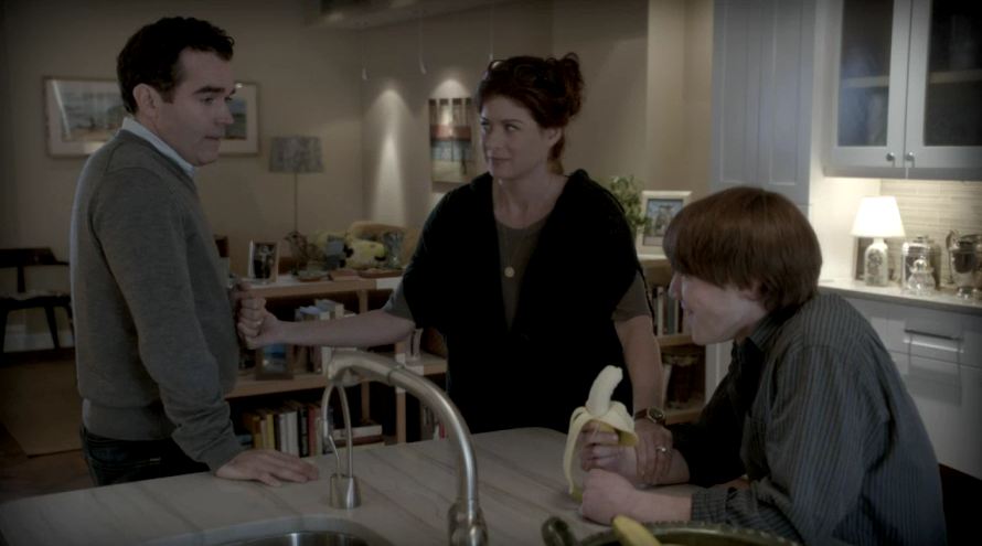 actors standing around kitchen island