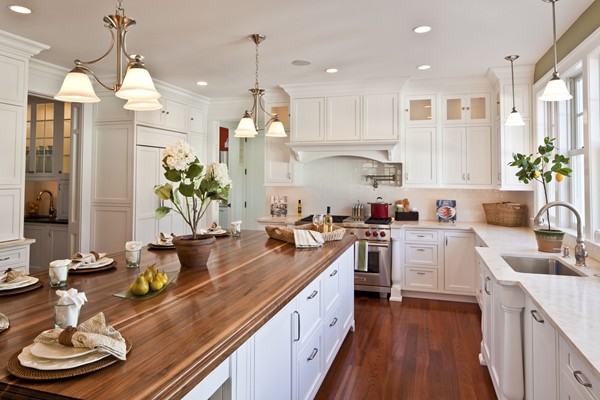 A large kitchen with stainless steel appliances and white cabinets