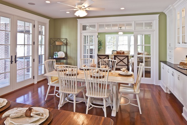 A dining room table and white chairs