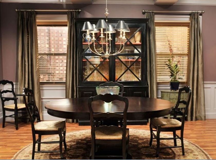 A dining room table in front of a window