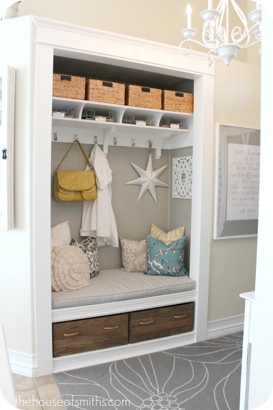 new mudroom nook in entry hall with padded bench, hooks and cubbies