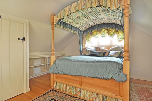 A bedroom with a bed in a room