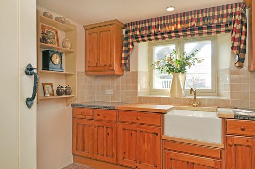 A kitchen with wooden cabinets and a sink