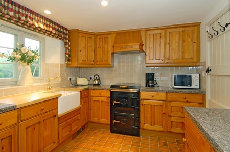 A kitchen with wood cabinets