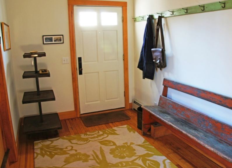 entry hall with bench and hooks for coats