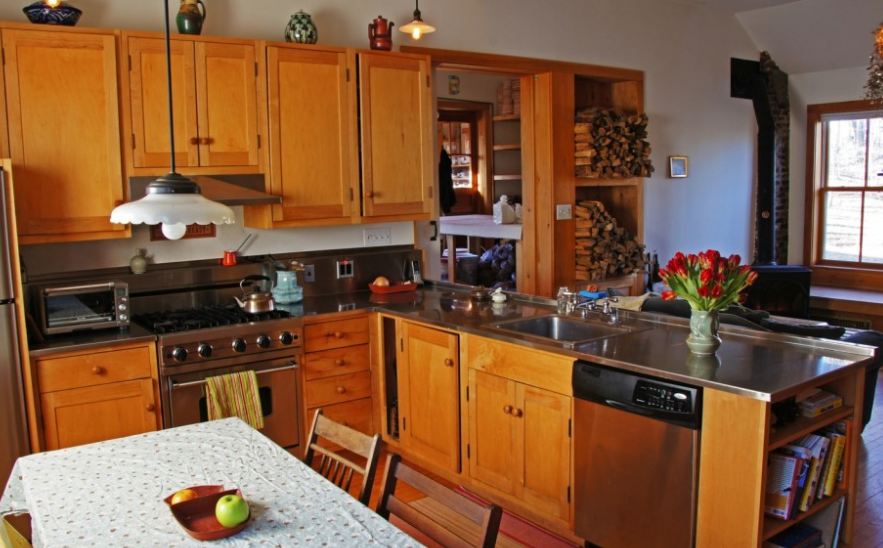 A large kitchen with stainless steel appliances and wooden cabinets