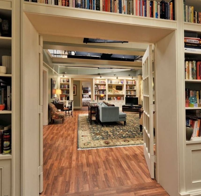 A living room filled with furniture and a book shelf