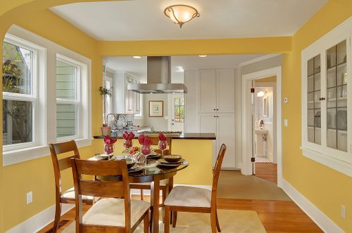 A dining room table in front of a window