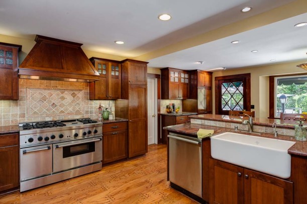 A large kitchen with stainless steel appliances and wooden cabinets